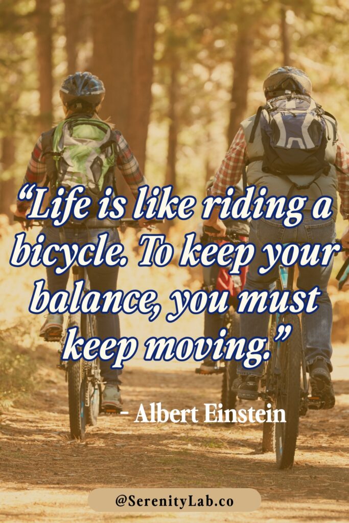 Two cyclists riding on a forest trail in autumn, seen from behind, with "Life is like riding a bicycle. To keep your balance, you must keep moving." – Albert Einstein.